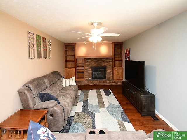 14824 Charles Plz, Omaha, NE 68154 - living room featuring ceiling fan, wood finished floors, a brick fireplace, and built in shelves