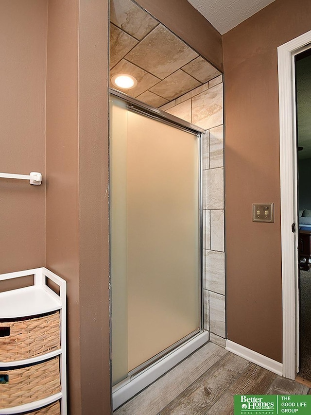 14824 Charles Plz, Omaha, NE 68154 - bathroom featuring wood finished floors and a stall shower