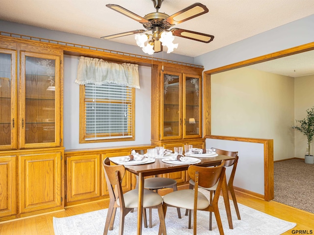 dining space with light wood-style floors and a ceiling fan