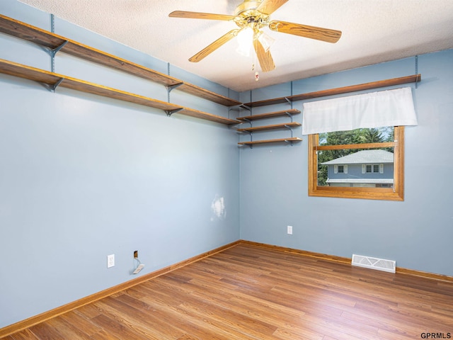 empty room with baseboards, light wood-style floors, and a ceiling fan