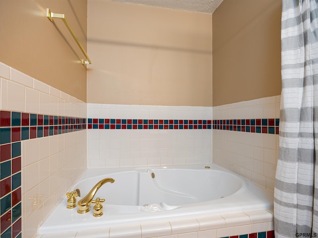 bathroom featuring a bath and a textured ceiling