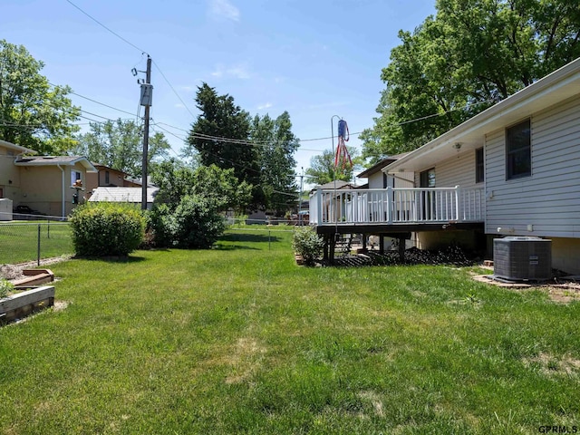 view of yard with a deck and central AC unit