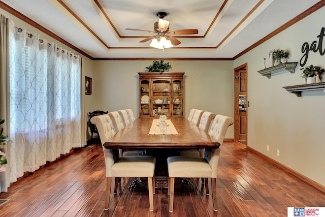 1714 S 14th Circle Dr, Beatrice, NE 68310 - dining area with a tray ceiling, ceiling fan, hardwood / wood-style floors, crown molding, and baseboards