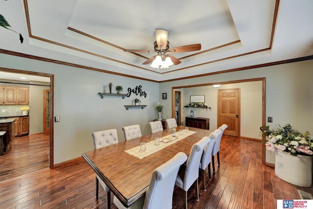 1714 S 14th Circle Dr, Beatrice, NE 68310 - dining room featuring a raised ceiling, hardwood / wood-style flooring, and ornamental molding