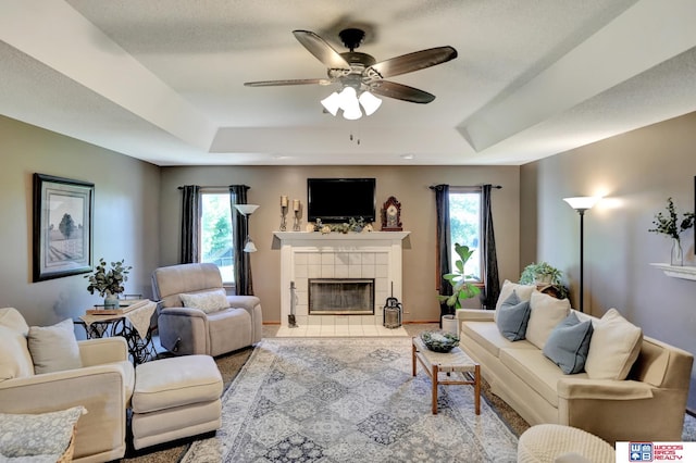 1714 S 14th Circle Dr, Beatrice, NE 68310 - living room featuring a raised ceiling, a fireplace, and a ceiling fan