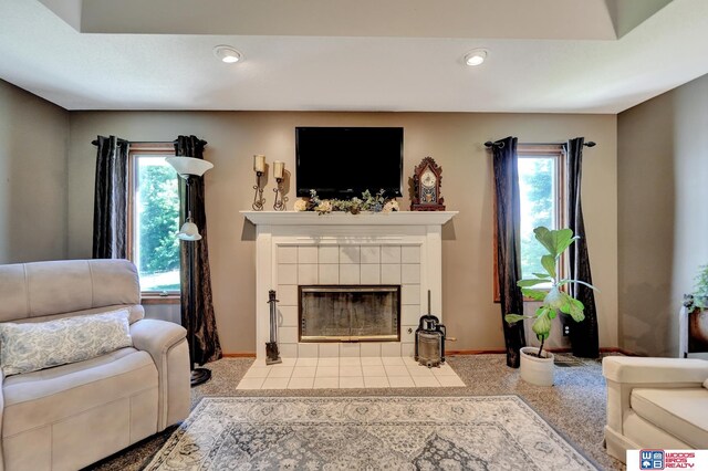 1714 S 14th Circle Dr, Beatrice, NE 68310 - carpeted living room featuring a tiled fireplace, baseboards, and recessed lighting