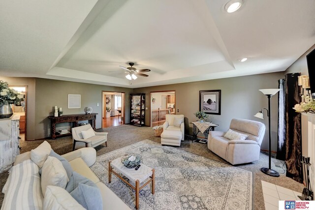 1714 S 14th Circle Dr, Beatrice, NE 68310 - carpeted living room featuring a raised ceiling, a ceiling fan, and recessed lighting