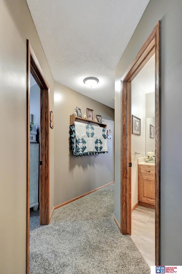 1714 S 14th Circle Dr, Beatrice, NE 68310 - hall with carpet floors, baseboards, and a textured ceiling