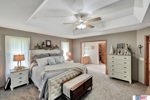 1714 S 14th Circle Dr, Beatrice, NE 68310 - bedroom featuring a raised ceiling, carpet flooring, a walk in closet, and a ceiling fan