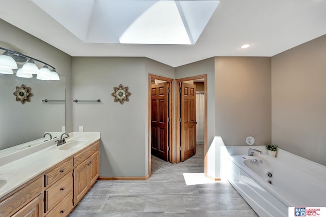 1714 S 14th Circle Dr, Beatrice, NE 68310 - full bathroom with a skylight, a whirlpool tub, double vanity, baseboards, and recessed lighting