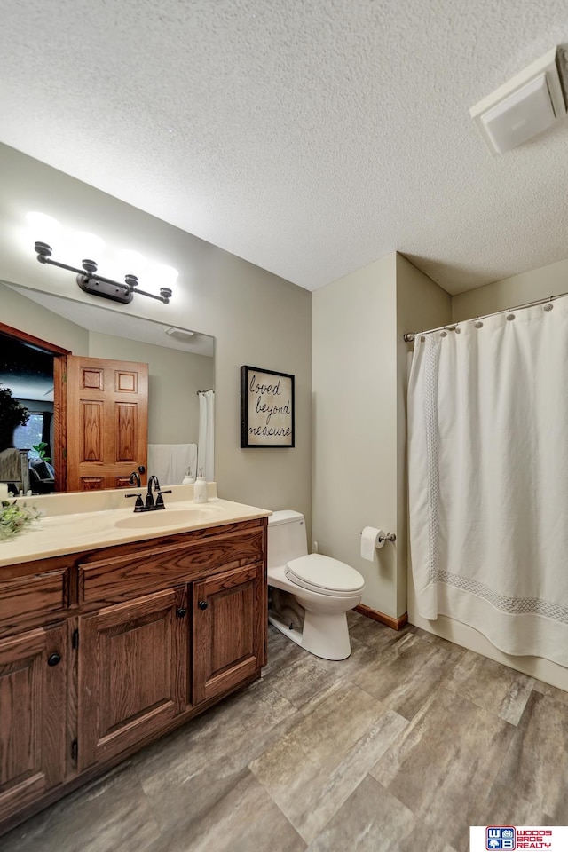 1714 S 14th Circle Dr, Beatrice, NE 68310 - full bath featuring toilet, vanity, a textured ceiling, and a shower with curtain