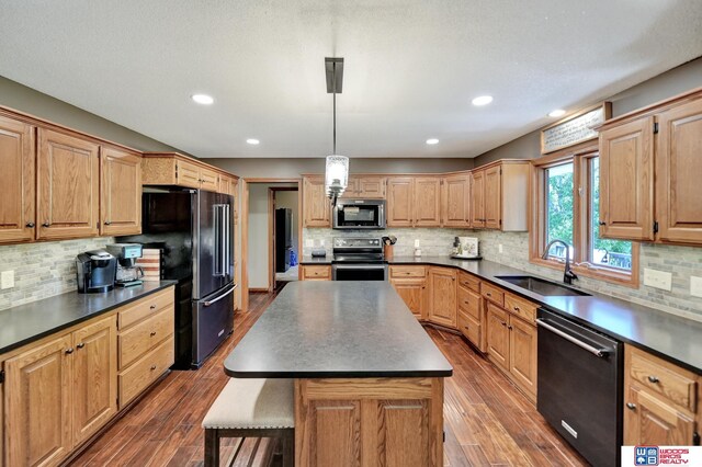 1714 S 14th Circle Dr, Beatrice, NE 68310 - kitchen featuring black appliances, a sink, dark countertops, and recessed lighting