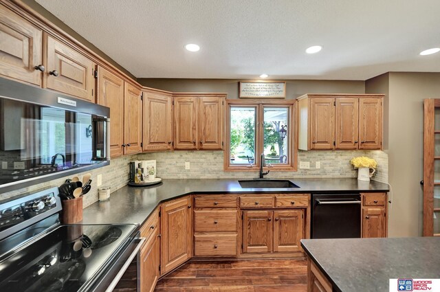 1714 S 14th Circle Dr, Beatrice, NE 68310 - kitchen with stainless steel range with electric cooktop, a sink, dark countertops, dark wood finished floors, and black dishwasher