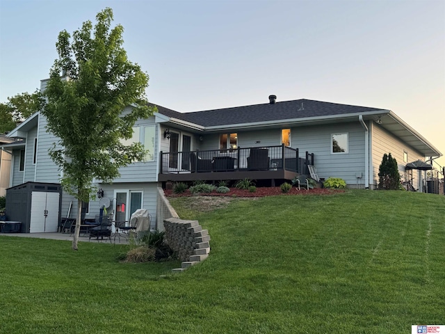 1714 S 14th Circle Dr, Beatrice, NE 68310 - back of property with a deck, a lawn, and a patio area