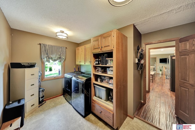 1714 S 14th Circle Dr, Beatrice, NE 68310 - washroom featuring cabinet space, separate washer and dryer, baseboards, and a textured ceiling