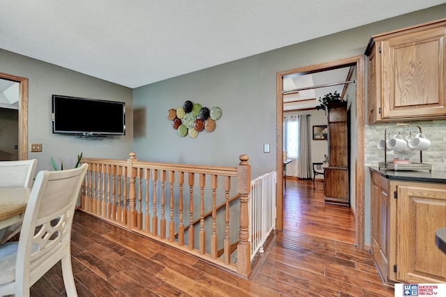 1714 S 14th Circle Dr, Beatrice, NE 68310 - hallway with an upstairs landing, wood finished floors, and lofted ceiling