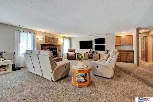 1714 S 14th Circle Dr, Beatrice, NE 68310 - living room featuring plenty of natural light, light colored carpet, a fireplace, and a textured ceiling