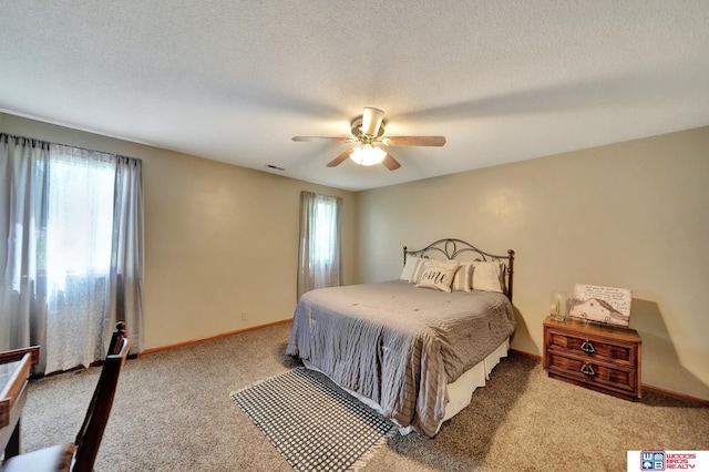 1714 S 14th Circle Dr, Beatrice, NE 68310 - bedroom with light colored carpet, ceiling fan, baseboards, and a textured ceiling
