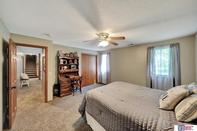 1714 S 14th Circle Dr, Beatrice, NE 68310 - bedroom with light colored carpet, a ceiling fan, a textured ceiling, and a closet