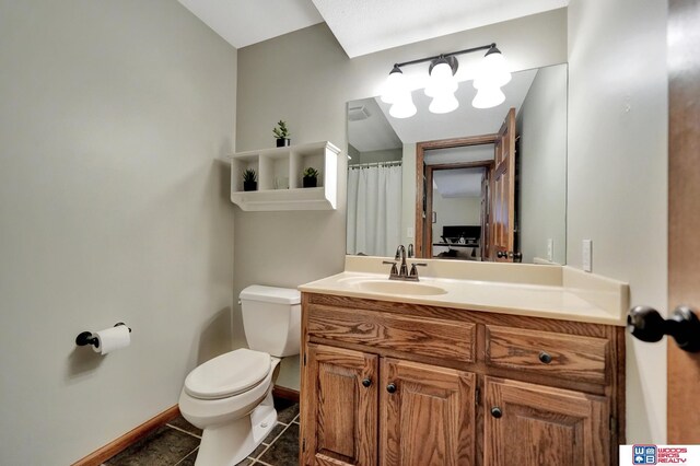 1714 S 14th Circle Dr, Beatrice, NE 68310 - full bath featuring toilet, baseboards, vanity, and tile patterned flooring