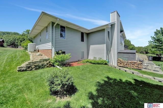 1714 S 14th Circle Dr, Beatrice, NE 68310 - view of home's exterior featuring a yard and a chimney