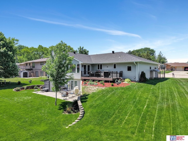 1714 S 14th Circle Dr, Beatrice, NE 68310 - back of property with a deck, a patio area, a yard, and a shingled roof