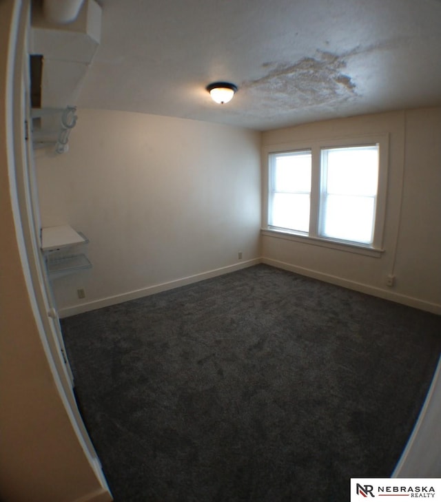 1941 J St, Lincoln, NE 68510 - empty room with dark colored carpet and baseboards