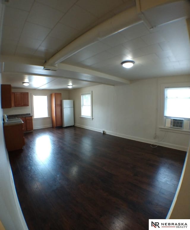 1941 J St, Lincoln, NE 68510 - spare room featuring dark wood finished floors, baseboards, cooling unit, and beam ceiling