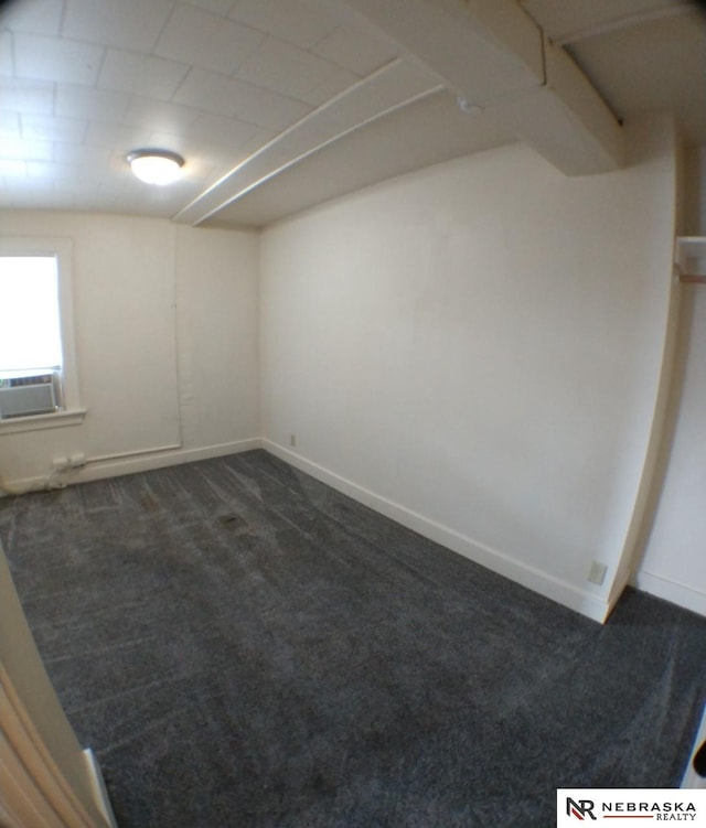 1941 J St, Lincoln, NE 68510 - unfurnished room featuring dark colored carpet, baseboards, and cooling unit