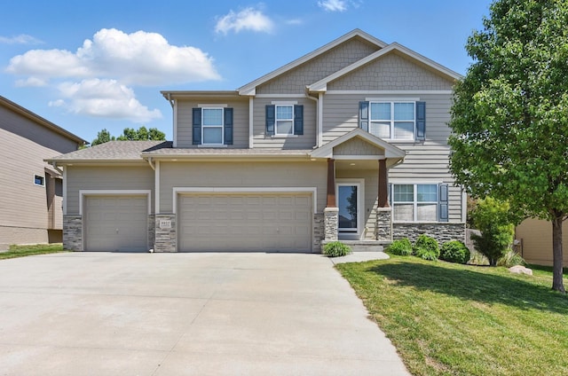 craftsman inspired home featuring stone siding, driveway, a front lawn, and an attached garage