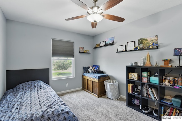 carpeted bedroom with baseboards and a ceiling fan