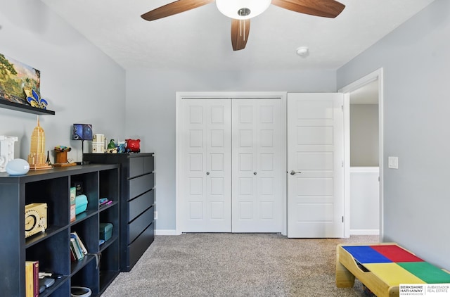 bedroom with carpet floors, a closet, a ceiling fan, and baseboards