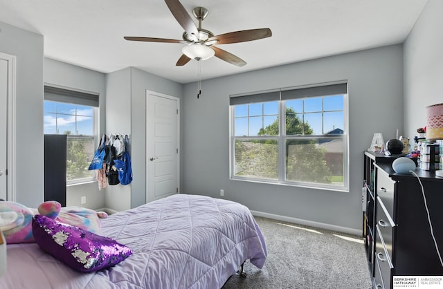 carpeted bedroom featuring baseboards and ceiling fan