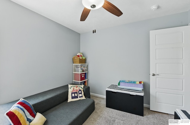 living area with carpet, ceiling fan, and baseboards