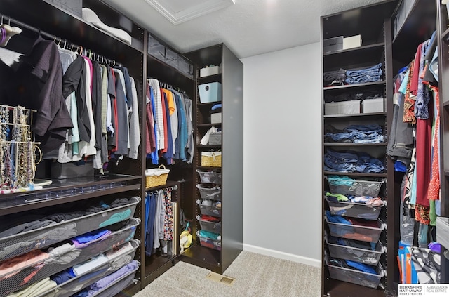 walk in closet featuring attic access