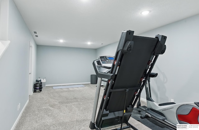 exercise area with carpet floors, baseboards, and recessed lighting