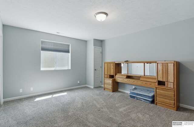 unfurnished bedroom featuring carpet flooring and baseboards