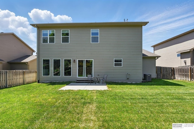 back of property with central AC unit and a patio
