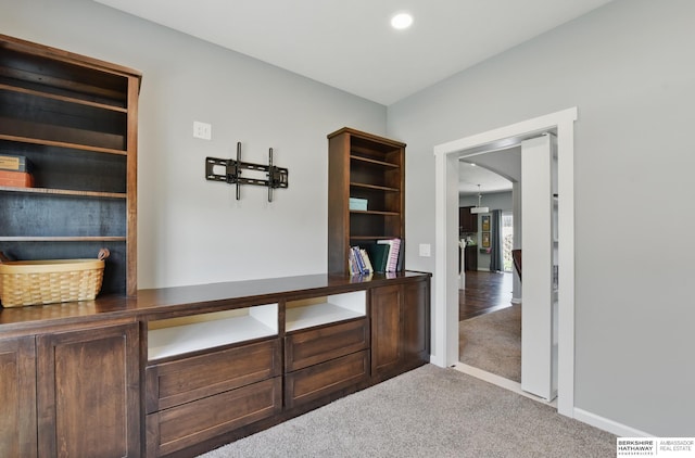 unfurnished office featuring carpet floors, baseboards, arched walkways, and recessed lighting