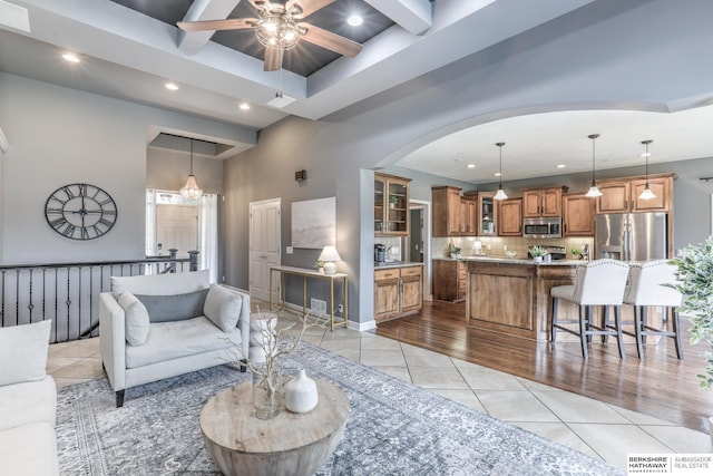 7309 S 196th Cir, Gretna, NE 68028 - living area with recessed lighting, a ceiling fan, light tile patterned floors, arched walkways, and coffered ceiling