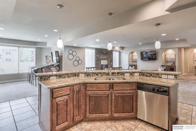 7309 S 196th Cir, Gretna, NE 68028 - kitchen featuring stainless steel dishwasher, arched walkways, open floor plan, a sink, and light stone countertops