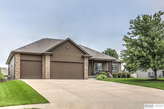 7309 S 196th Cir, Gretna, NE 68028 - view of front of property featuring an attached garage, driveway, a front lawn, and brick siding