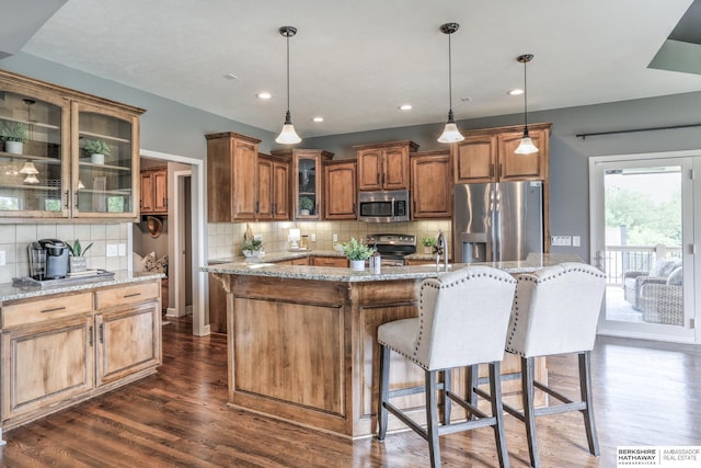 7309 S 196th Cir, Gretna, NE 68028 - kitchen with appliances with stainless steel finishes, dark wood-style floors, backsplash, glass insert cabinets, and light stone countertops