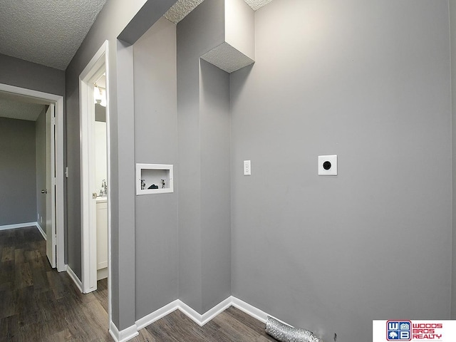 washroom featuring hookup for an electric dryer, hookup for a washing machine, dark wood finished floors, baseboards, and a textured ceiling