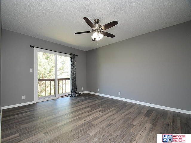 spare room with ceiling fan, dark wood-type flooring, baseboards, and a textured ceiling