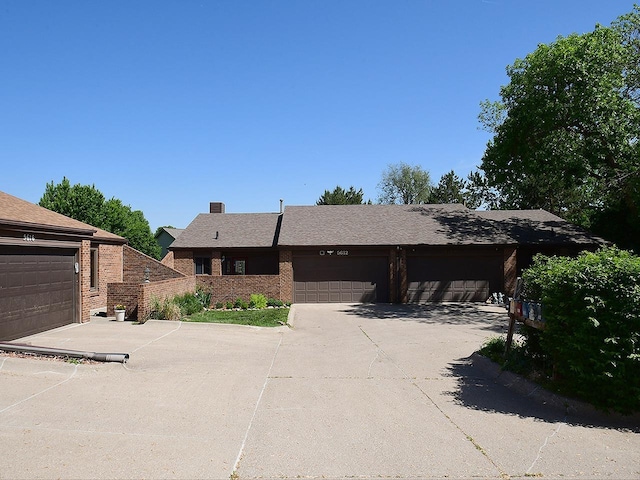 ranch-style home with brick siding and driveway