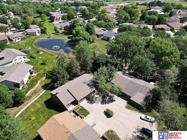 aerial view of property's location with nearby suburban area and a large body of water