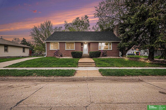 1405 E Linden Ave, Fremont, NE 68025 - view of front of home with brick siding and a yard