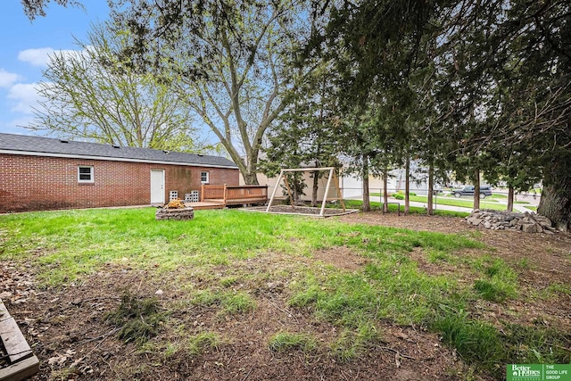 1405 E Linden Ave, Fremont, NE 68025 - view of yard featuring an outdoor fire pit and a deck