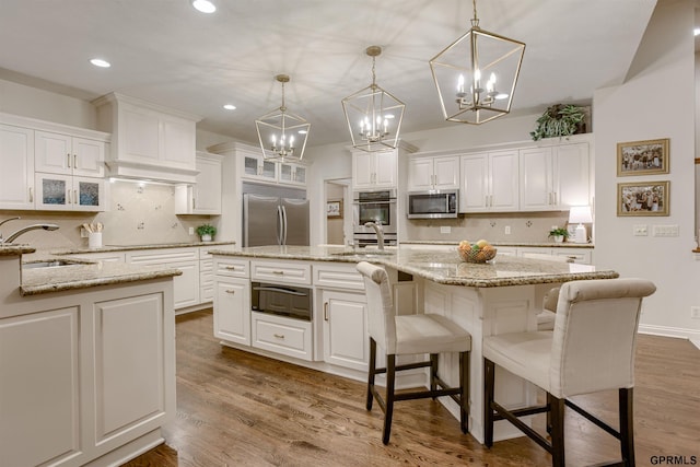 3835 S 179th Ter, Omaha, NE 68130 - kitchen with stainless steel appliances, a warming drawer, a sink, a chandelier, and recessed lighting